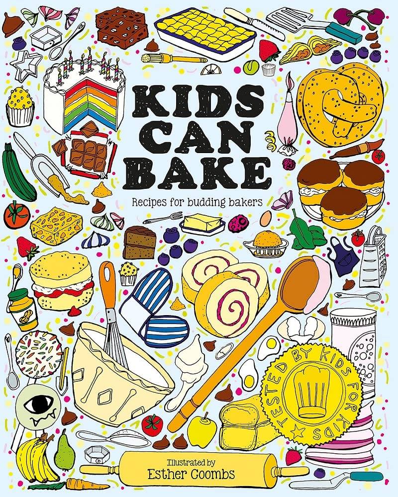 Kids Can Bake Recipe Book a photograph of a recipe book with a white cover covered in food and baking themed illustrations and the words Kids Can Bake for budding bakers in the centre