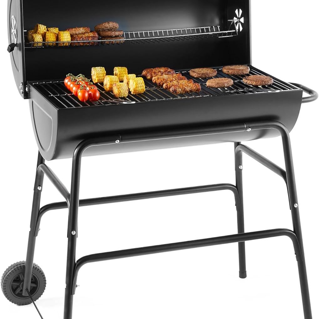 A photograph of a black barrel shaped barbecue with metal frame and legs and wheels on one end allowing it to be portable a 2 in 1 barbecue and smoker