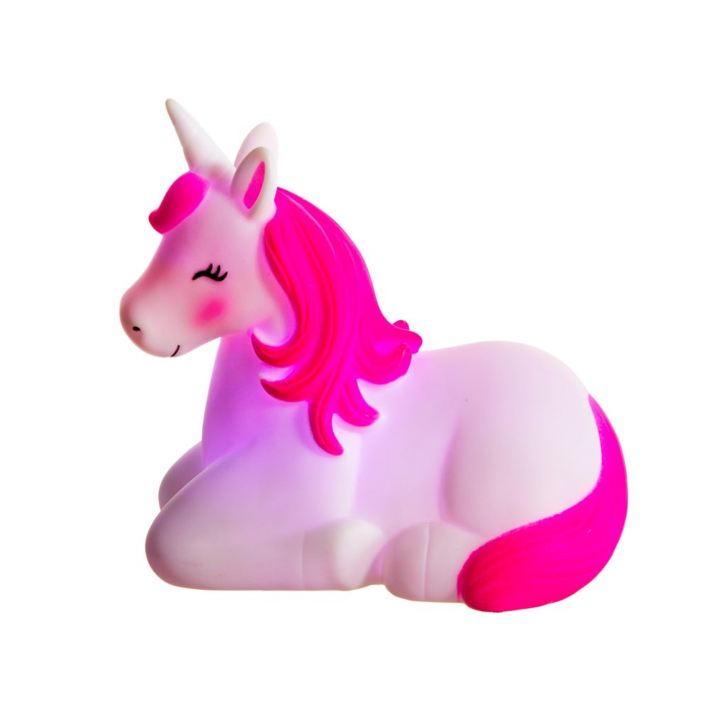 a photograph of a Sass & Belle Rechargeable Unicorn Night Light that is glowing blue with a white body and pink mane and tail the unicorn is lying down with its head up