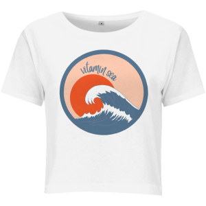 a photo of a white ladies cropped t-shirt with a round vitamin sea design featuring a large wave in front of a low orange sun