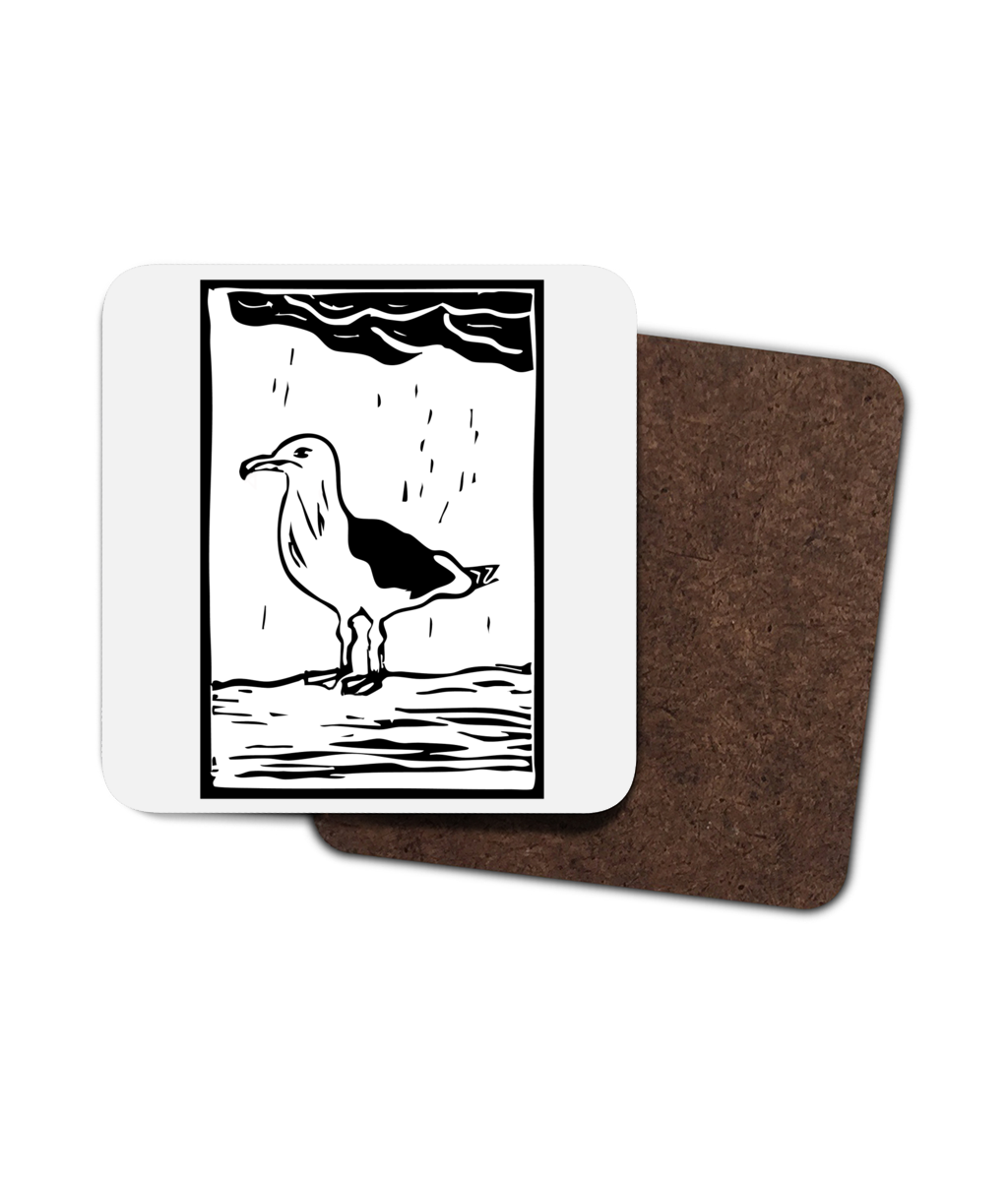 a photograph on a white background of a white coaster featuring a seagull linocut design