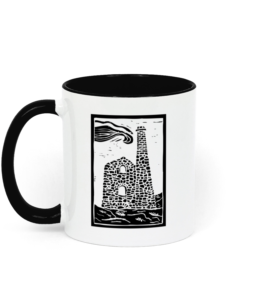 a photograph of a white background and a white mug with black interior and handle, featuring a linocut design of a Cornish engine house